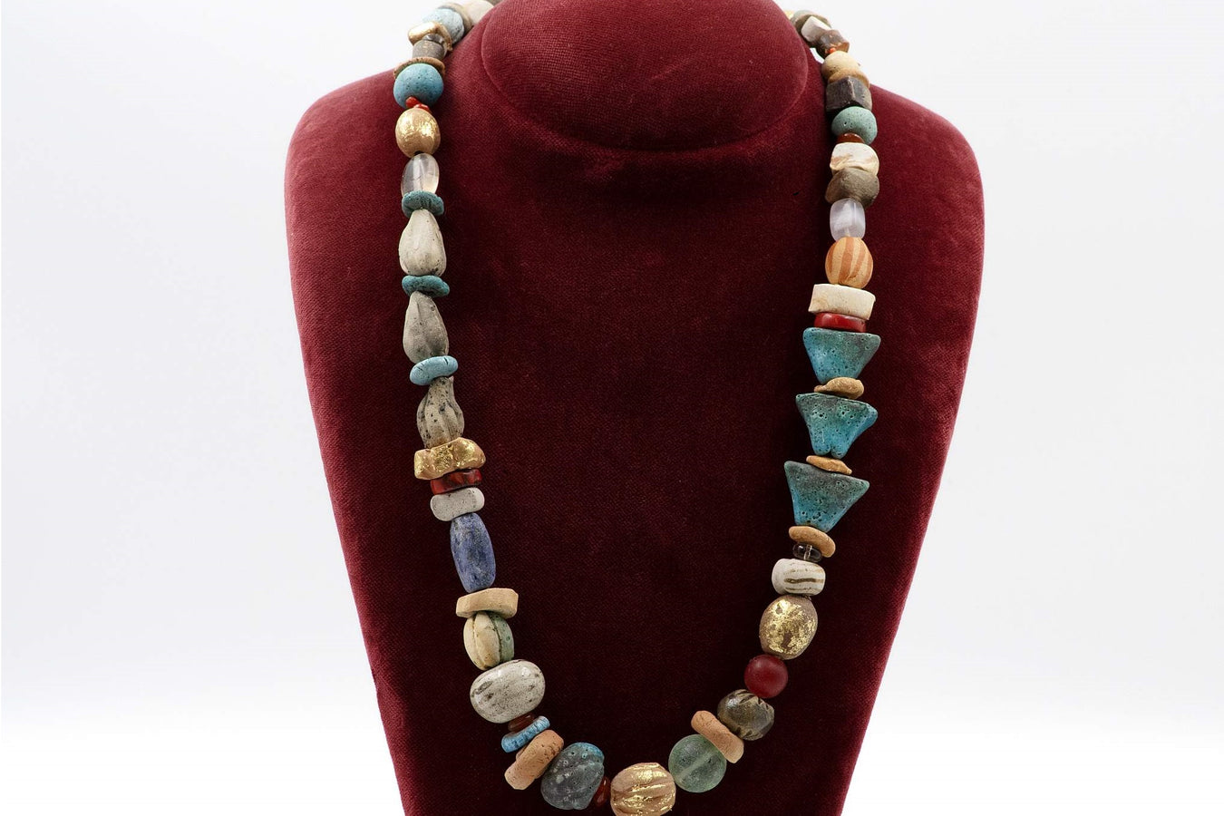 Unique necklace with hand made colorful plain or glazed or gilded ceramic beads, glass, coral and lapis decorative elements