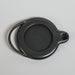 Black ceramic oil lamp on a beige background