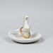 White ceramic jewlery holder with a small bird design on a gray background