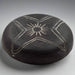 Black ceramic bowl with white geometric patterns on a gray background