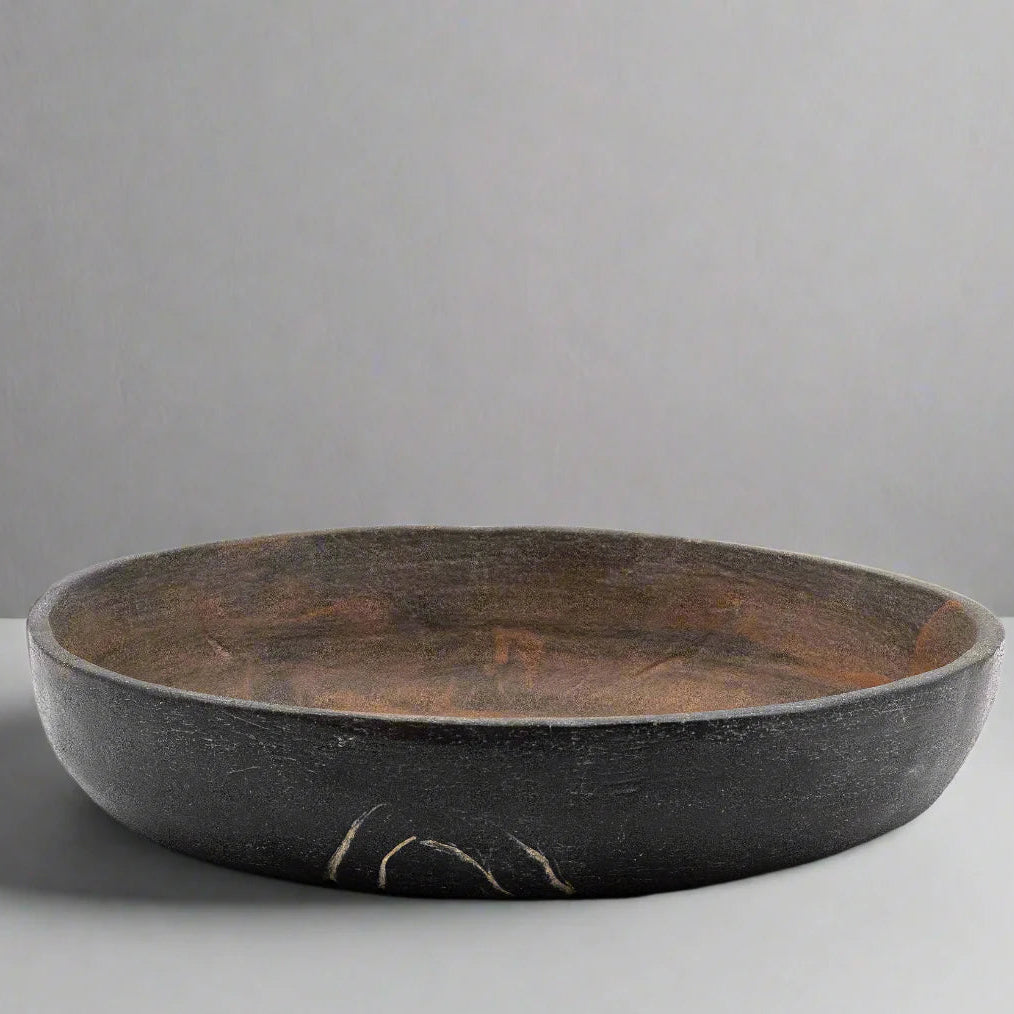 Large ceramic bowl with a textured surface on a neutral background