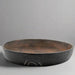 Large ceramic bowl with a textured surface on a neutral background