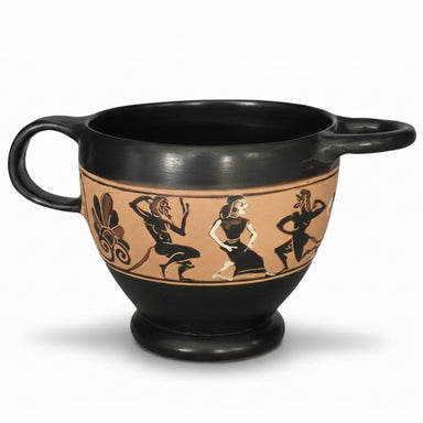 An ancient Greek black figure mug with vertical handles depicting a group of dancing maenads and satyrs.