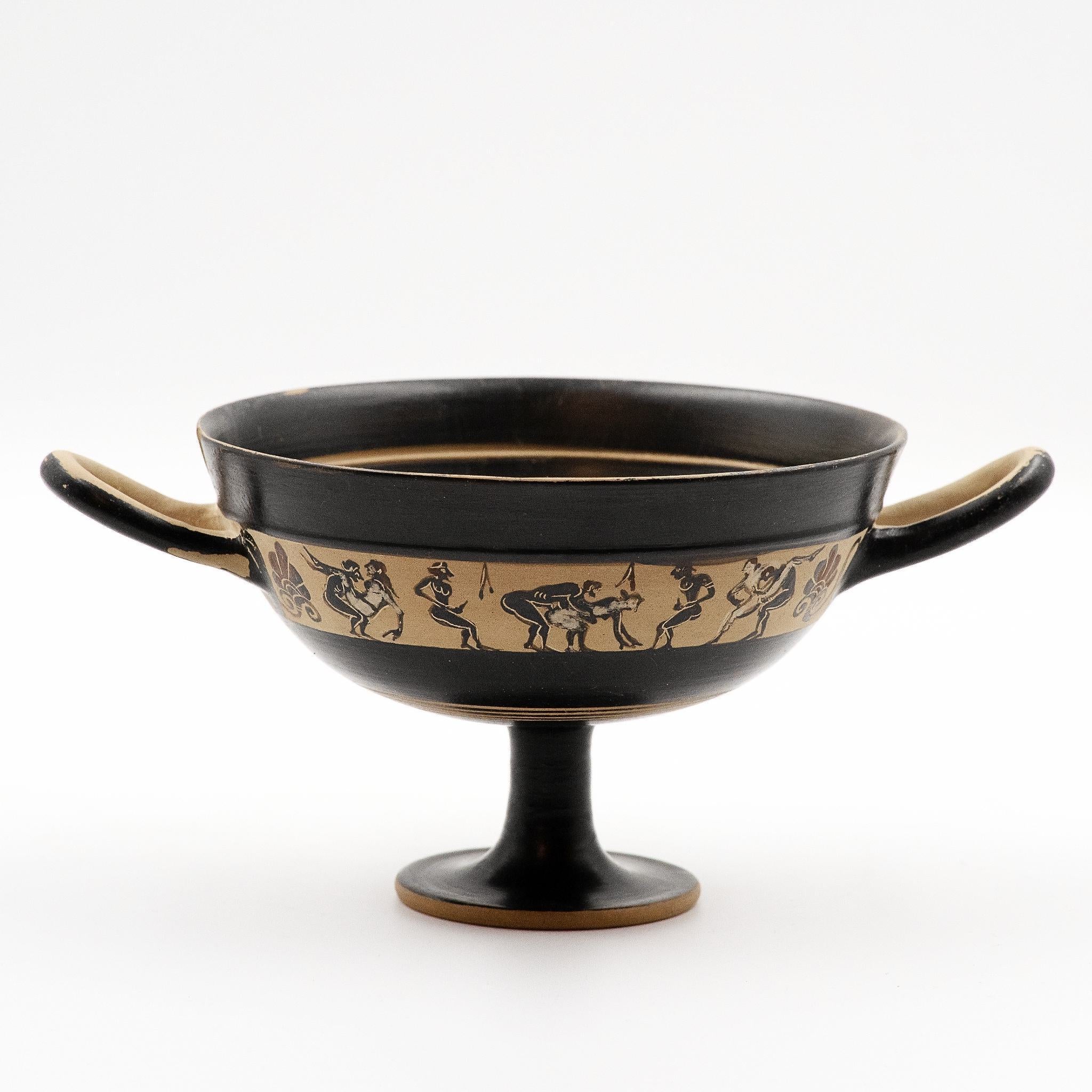 This image displays a finely crafted Black-Figure Kylix, featuring a band of miniature decoration that illustrates intimate scenes of men and women. The kylix, originating from ancient Greece, circa 550–500 BC, bears the marks of black-figure pottery with its elegant and stylized depiction of the erotic scenes.