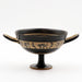 This image displays a finely crafted Black-Figure Kylix, featuring a band of miniature decoration that illustrates intimate scenes of men and women. The kylix, originating from ancient Greece, circa 550–500 BC, bears the marks of black-figure pottery with its elegant and stylized depiction of the erotic scenes.