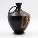 An ancient Greek black figure lekythos with a depiction of two figures on the side.