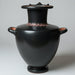 Black ceramic vase with red detailing on a gray background