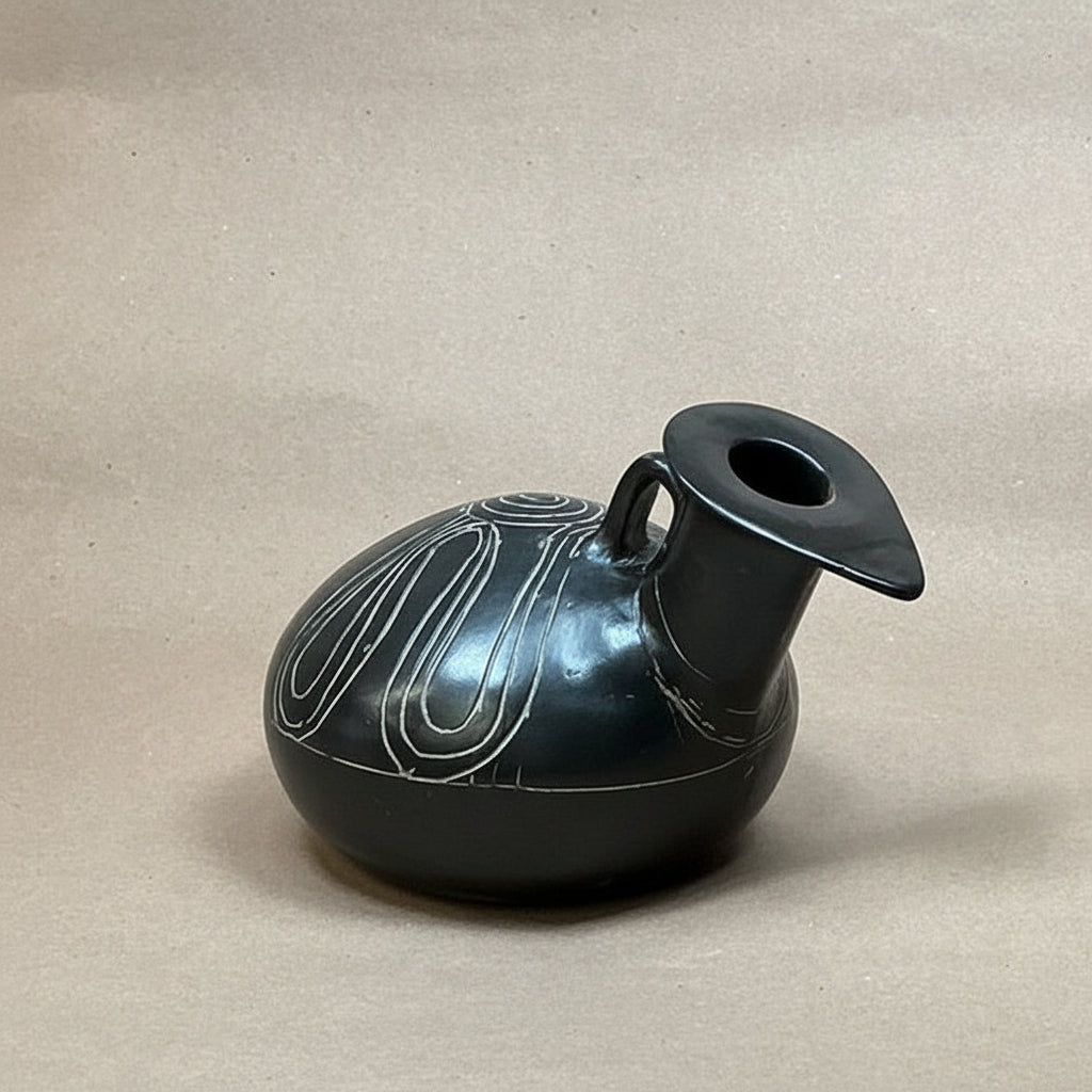 Black ceramic jar on a brown surface inside an open silver suitcase.