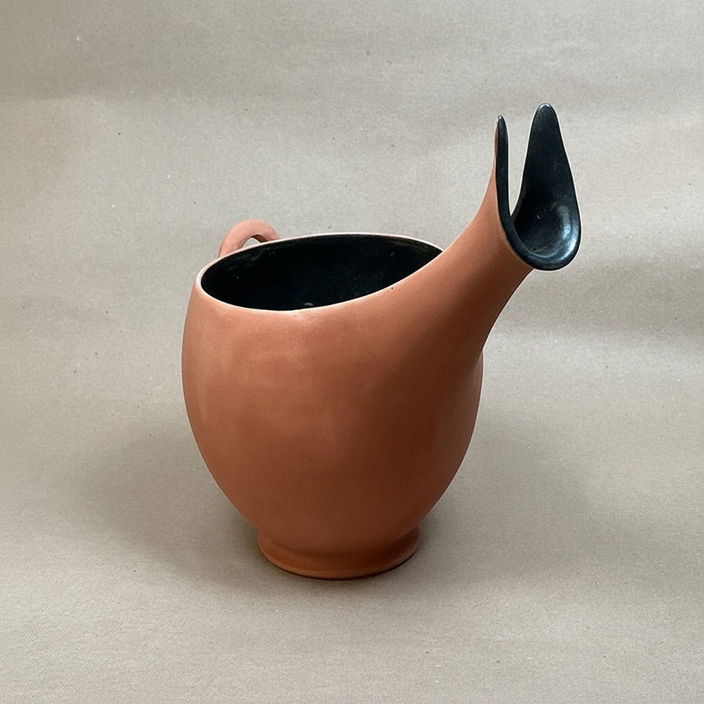 Ceramic teapot on a beige surface