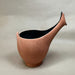 Ceramic vase with a unique design on a plain background