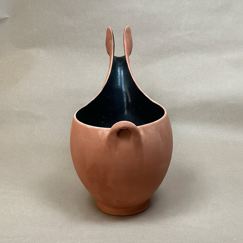 Ceramic vase with a unique design on a plain background