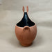 Ceramic vase with a unique design on a plain background