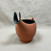 Ceramic cup with a black handle on a plain background