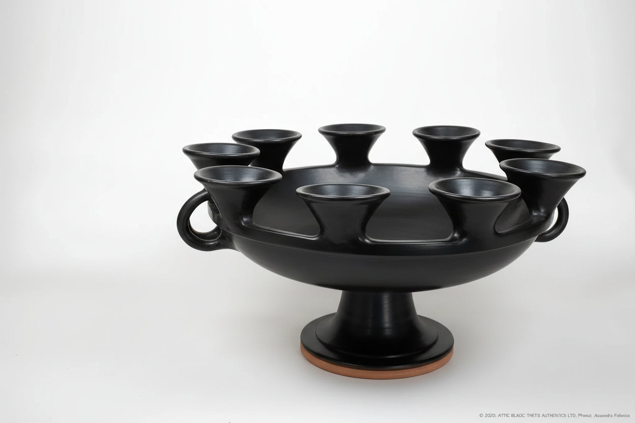Handcrafted black ceramic ancient Greek kylix with multiple cup-like spouts and pedestal base