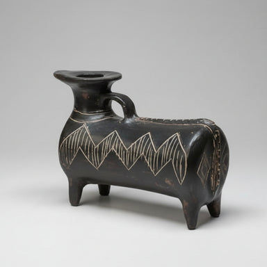 Black ceramic vase with geometric patterns on a gray background