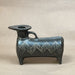 Small black decorative object on a beige background