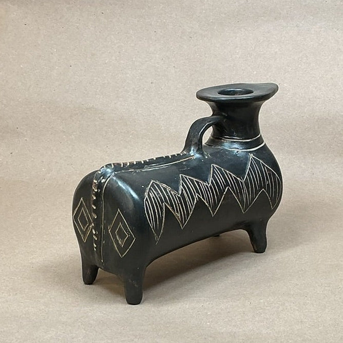 Decorative vase on a metal surface with a neutral background