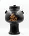 A black ceramic psykter with red-figure decoration depicting satyrs, a rounded body with a foot, and a short neck.