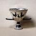 Ceramic cup with handles and rooster design on a beige background