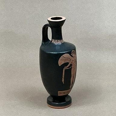 Black ceramic vase with red-figure decoration on a white background