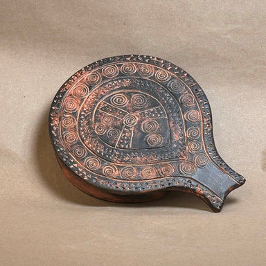 early bronze age Cycladic ceramic dish in the form of a frying pan with incised spiral patterns 