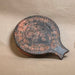 early bronze age Cycladic ceramic dish in the form of a frying pan with incised spiral patterns 