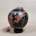 Decorative egg shaped ceramic box with classical design on a textured surface