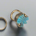 Ring with turquoise stone and gold accents on a white background