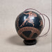 Decorative egg with ancient Greek design on a beige background
