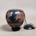 Decorative gourd with horse designs on a beige background