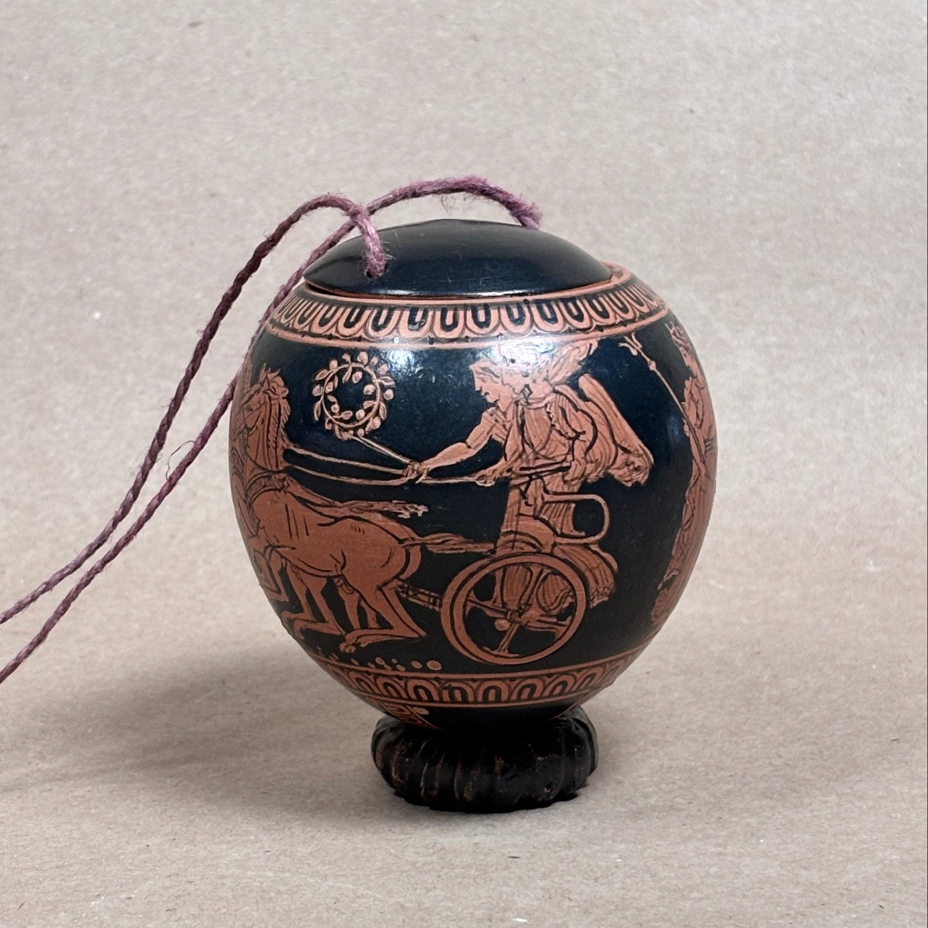 Decorative urn with classical design on a neutral background