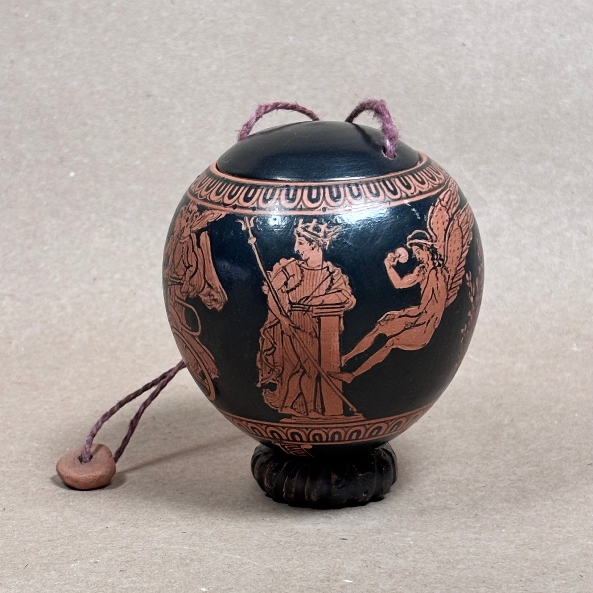 Decorative object with intricate designs on a light gray background
