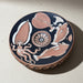 Decorative ceramic plate with marine animal designs on a neutral background