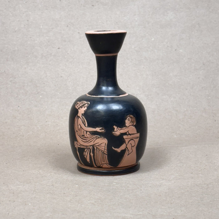 Black vase with red-figure decoration of two figures on a gray background