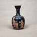 Black vase with red-figure decoration of two figures on a gray background