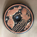 Decorative plate with fish and octopus design on a beige background