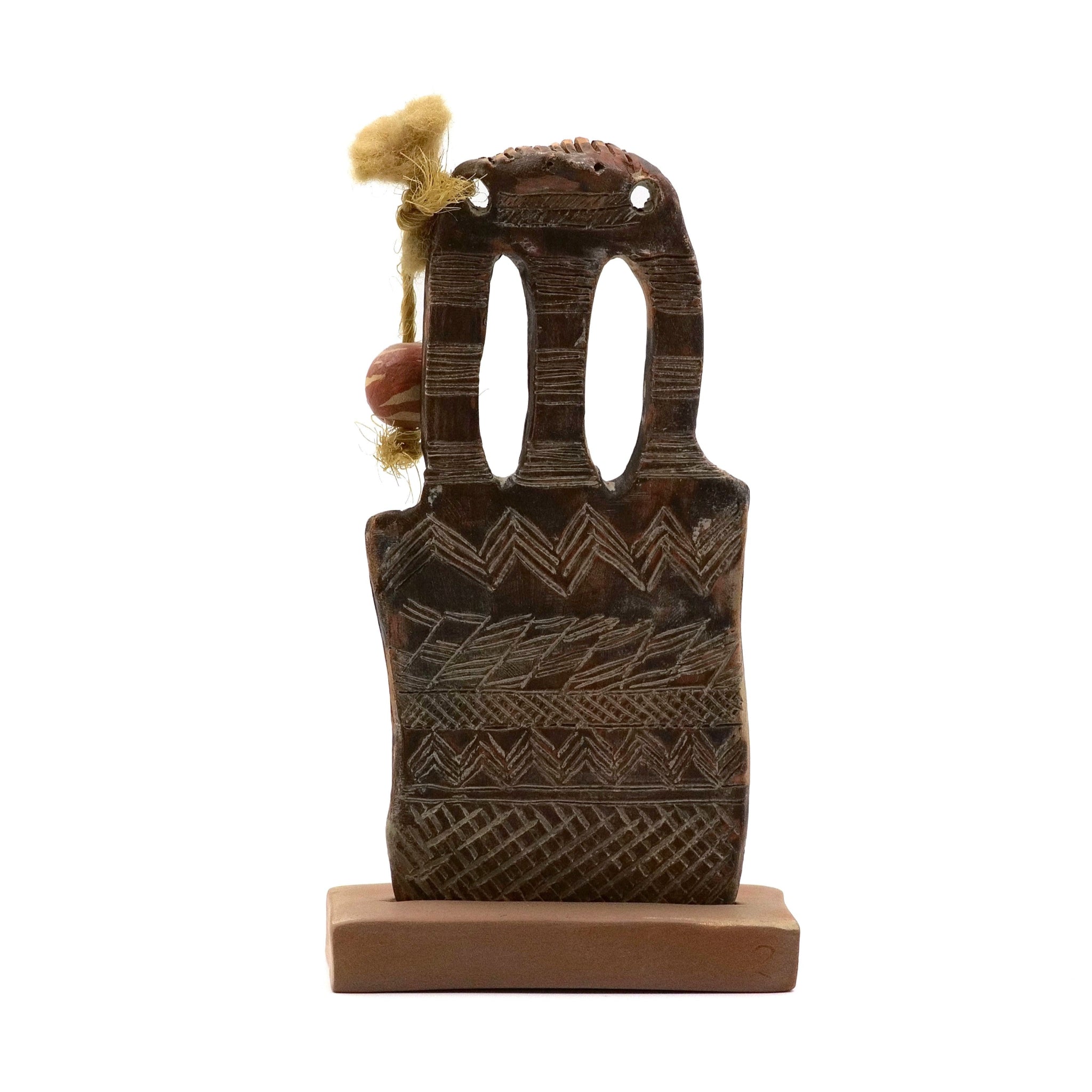 Decorative wooden object with intricate carvings on a white background