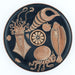 A photograph of a round ceramic plate with a reproduction of an Apulian Fish Plate design, featuring marine life including an octopus and various fish, primarily in brown tones on a black background.