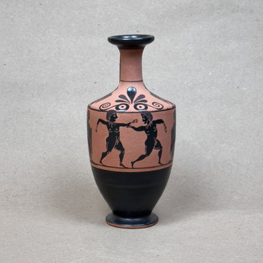 Ceramic vase with black and red design on a gray background