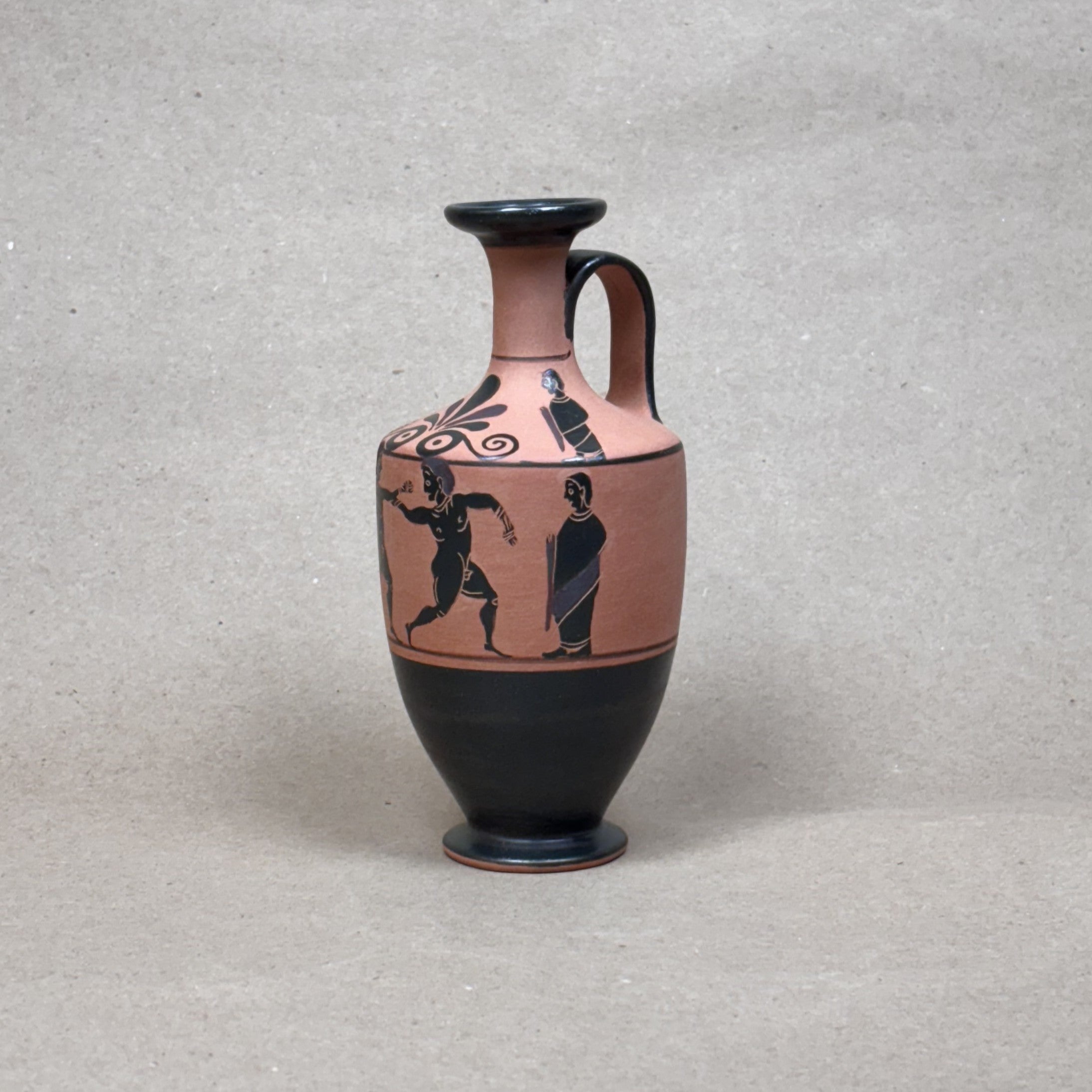 Ceramic vase with black-figure design on a gray background