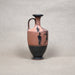 Ceramic vase with black and red designs on a gray background