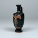 Black vase with brown decorative figure on a gray background