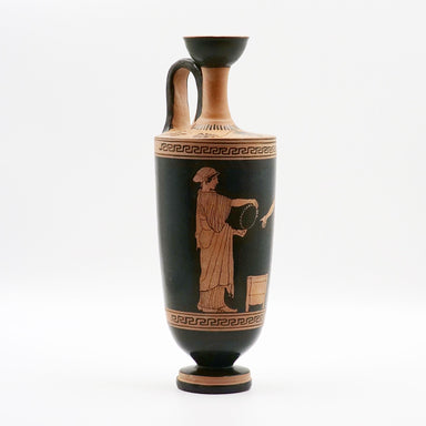 A black and white ceramic vase with a classical Greek design, featuring an illustration of a person throwing pottery on the side.