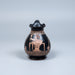 Ceramic vase with decorative design on a light gray background
