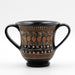A black ceramic drinking cup with two handles, featuring a stylized foliate pattern and other decorative motifs.