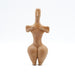 A clay figurine with a bird-like head and human body, representing a prehistoric handmade idol.