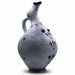 This image features a hand-formed ceramic nippled ewer, known as a Thera breasted jug or Mastoprochos, from the Cyclades dating back to the Middle to early Late Bronze Age. The vessel is crafted to represent both functional and ritualistic uses, highlighted by its distinctive plastic breast-like feature and ornate decorations.
