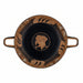 A black and red figure Kylix with youth lifting a amphora and galleys sailing on waves, with a wreath and a red band on the lip.