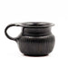 A black glazed ribbed mug with neat reeding and a double handle, reminiscent of ancient Greek pottery.