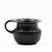 A black glazed ribbed ceramic mug with a double handle and rope-like incisions at the junction of the body and rim.